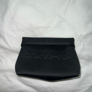 black skims small toiletry bag